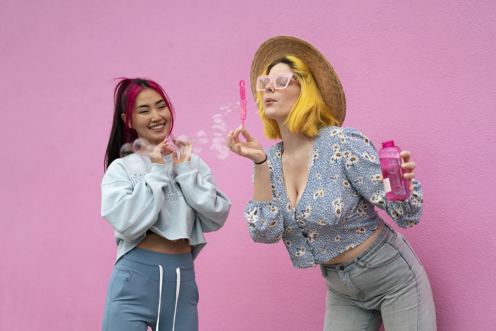 young-women-with-dyed-hair-near-pink-wall